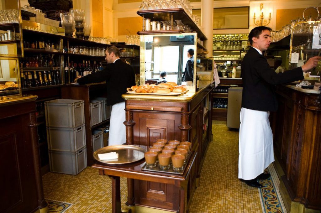 Waiters preparing their trays at the Café Les Deux Magots, Paris