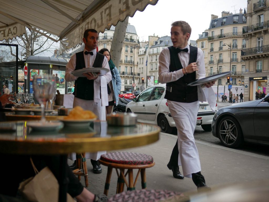 Waiters serving at Parisian café