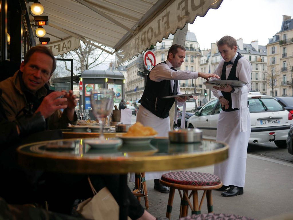 Waiters helping each other at Parisian café