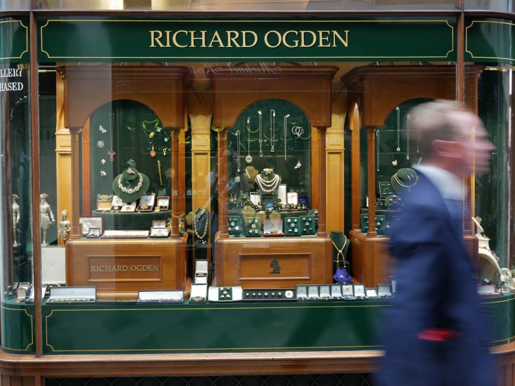 A gentleman walking by Richard Ogden jewelry store in London.