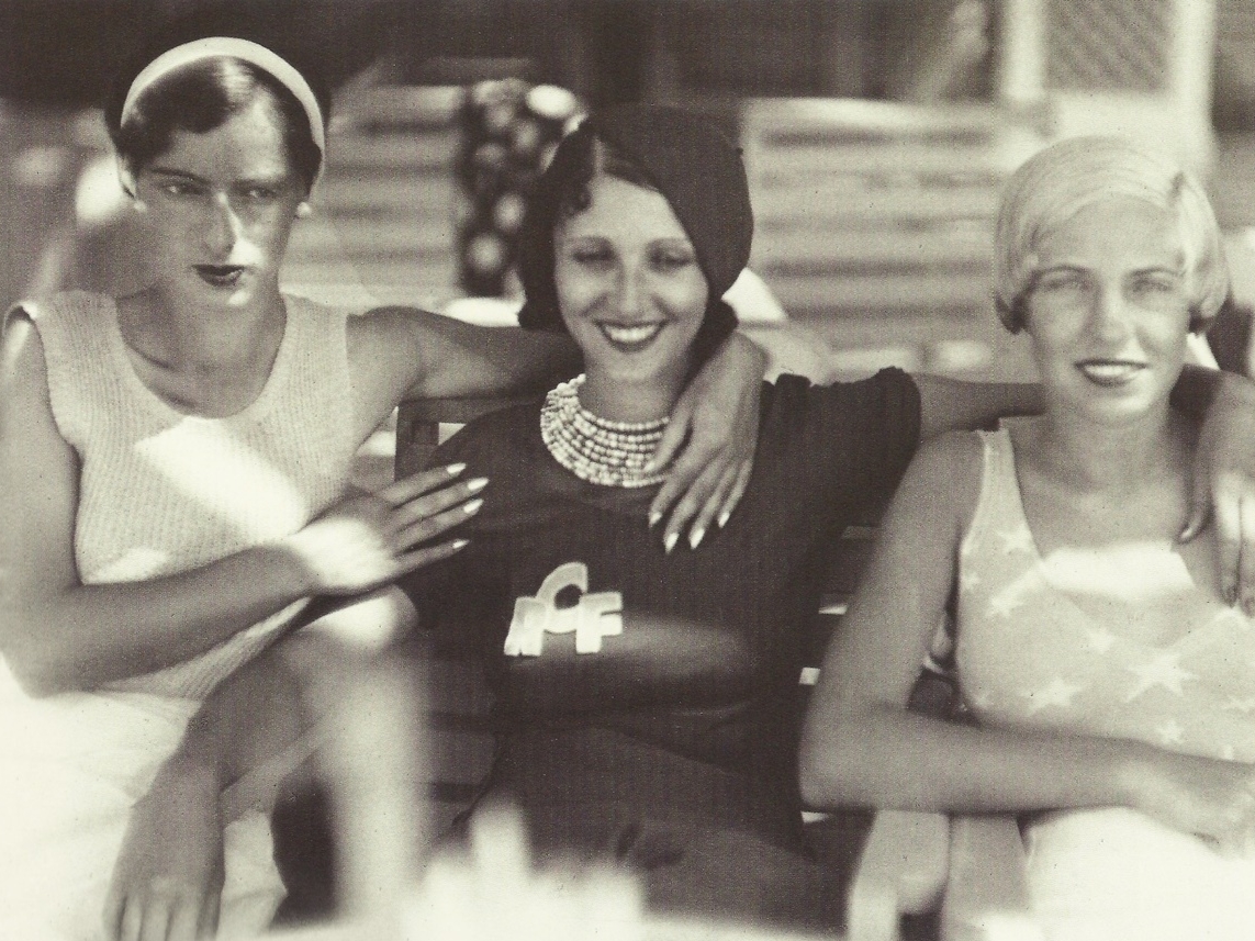young girlfriends posing under the shade, circa 1930.