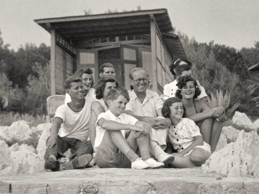 The Kennedy family posing outside a cabana at the Hotel du Cap d'Antibes in Antibes.