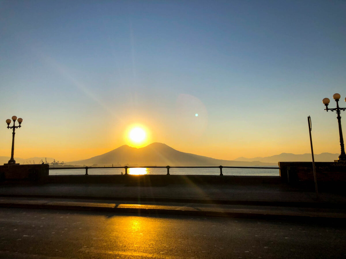 the sun rises from Mount Vesuvius